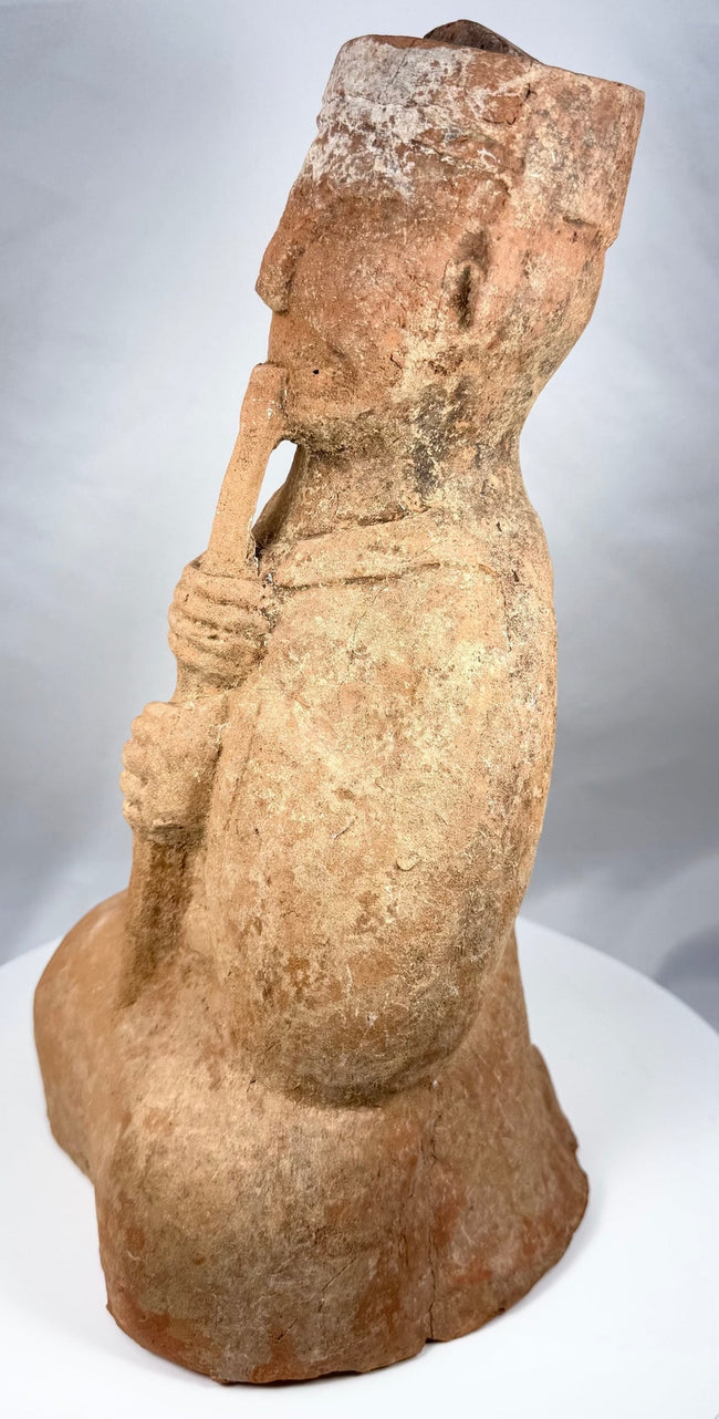 Profile of an ancient Chinese musician holding a vertical pipe