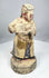Chinese temple attendant holding a ceremonial vessel in both hands