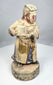 Chinese temple attendant holding a ceremonial vessel in both hands