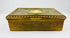 Antique gold decorative box showing engraved floral patterns along the side on a white background.