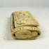 Carved bone snuff box end showing detailed woven and knotted relief patterns, attributed to Napoleonic POW craftsmanship.