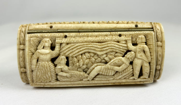 Alternate front panel of a Napoleonic POW carved bone snuff box with relief figures and textured landscape carving on a white background.