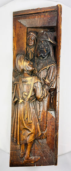 High-relief Renaissance-transition carving on solid oak, featuring two medieval-style figures.