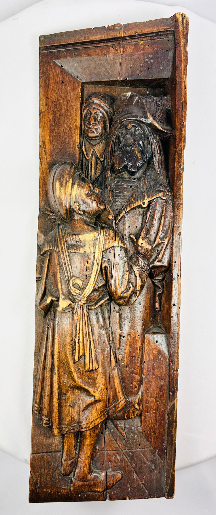 High-relief Renaissance-transition carving on solid oak, featuring two medieval-style figures.