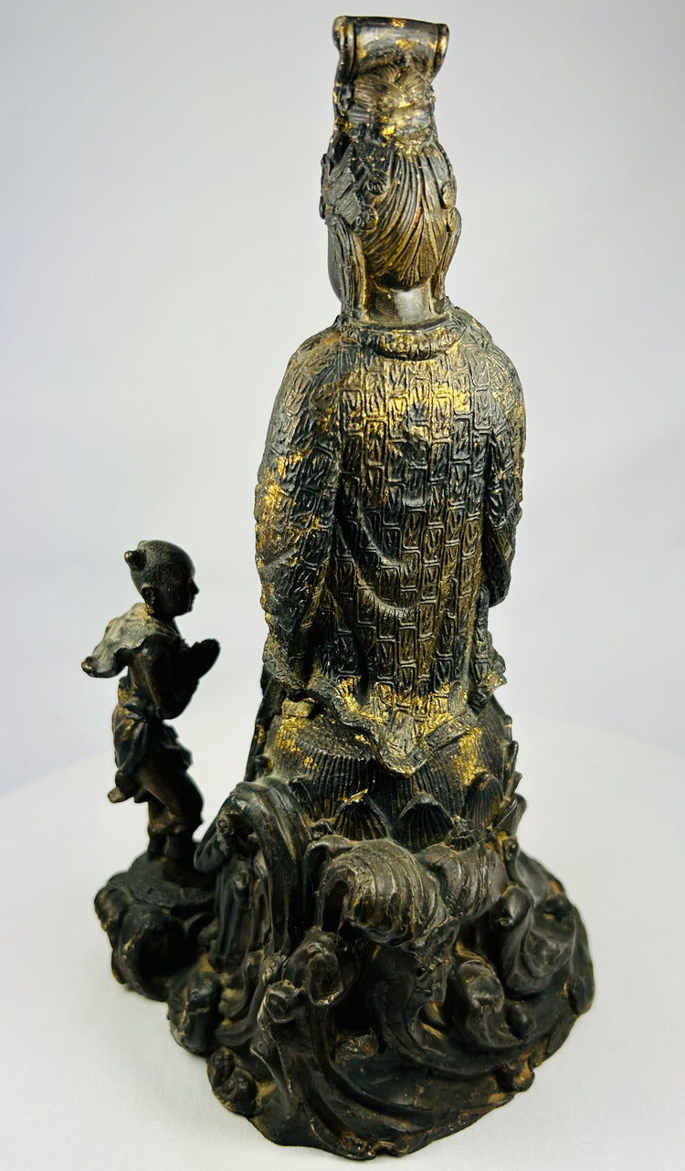 Back view of antique Thai bronze Guanyin sculpture, displaying robe drapery, halo form, and natural patina.