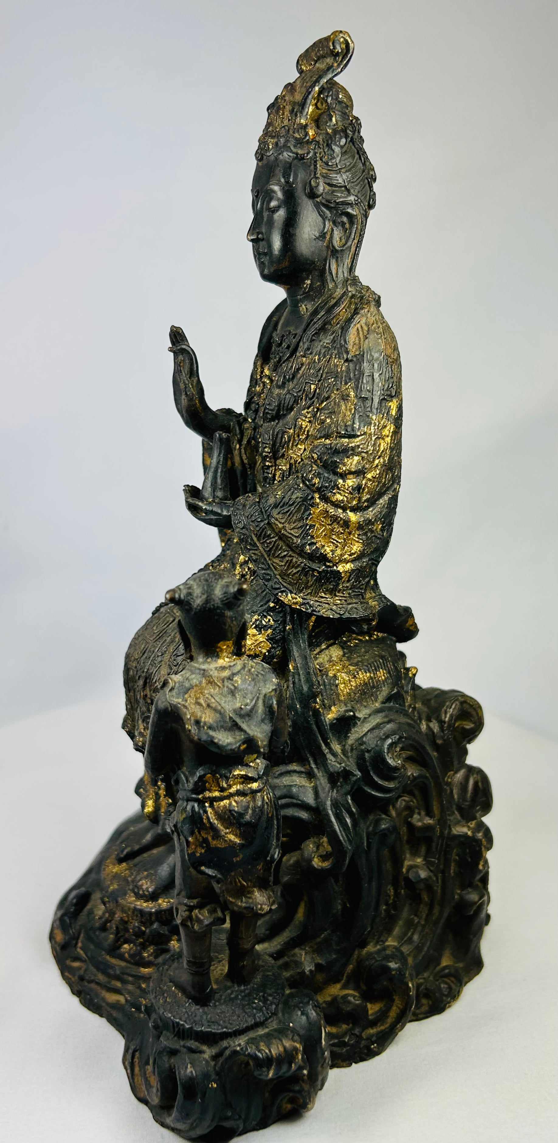 Right-side profile of Thai bronze Guanyin with child attendant, highlighting detailed casting and remaining gilt traces.