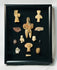Ancient terracotta and stone artifacts arranged in a curated Pre-Columbian study set.