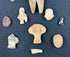 Archaeological terracotta figurines and stone relics from ancient Mesoamerica displayed together.