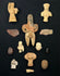 Pre-Columbian terracotta figurines, stone blades, and amulets arranged on a black display background.