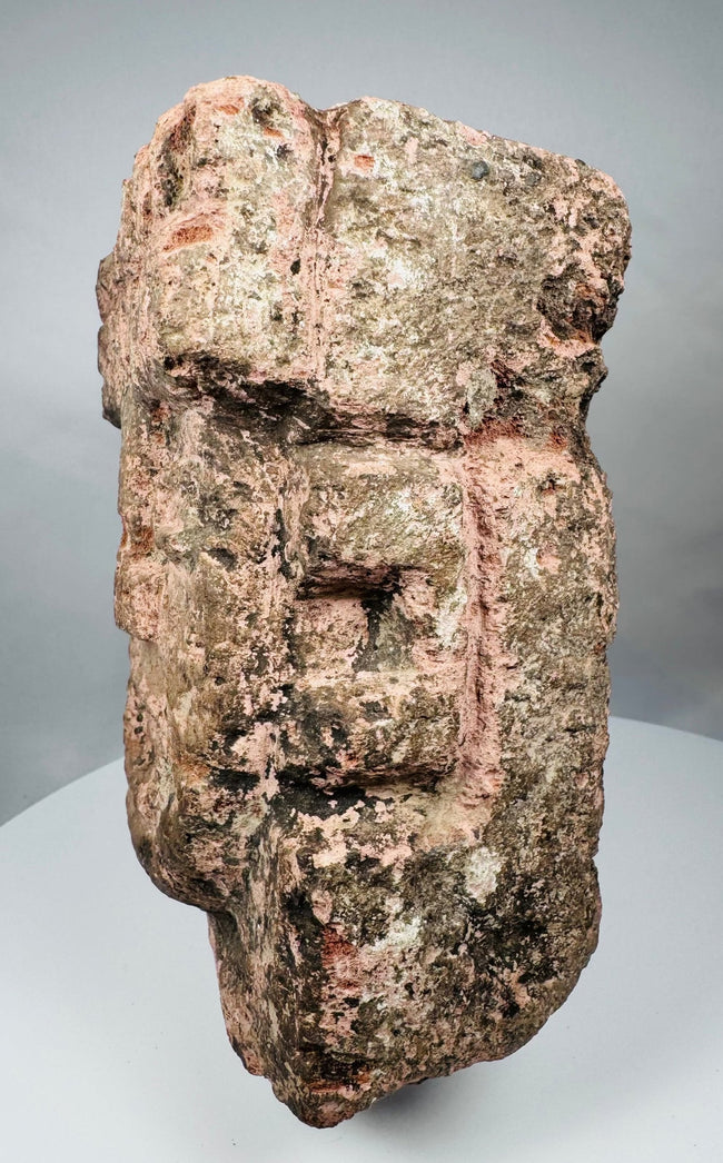 Profile of a Pre-Columbian stone hacha-style sculpture