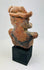 Rear view of Pre-Columbian Nayarit figure showing headdress and back surface wear.