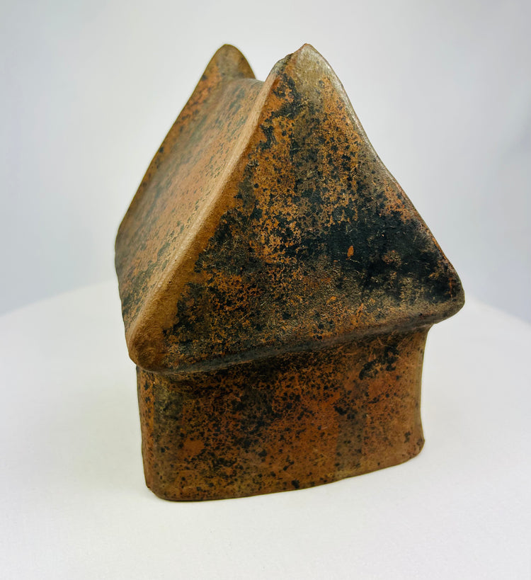 Angled view of a Pre-Columbian terracotta house model with textured roof.