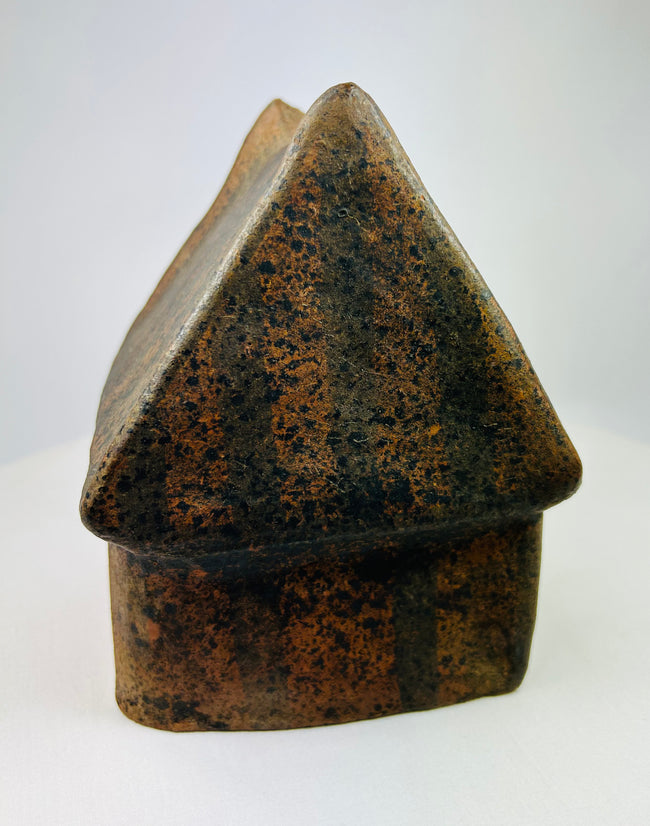 Side view of terracotta house model from West Mexico with ribbed roof texture.