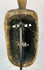 Rear view of a ceremonial wooden mask revealing tool marks and structural carving.