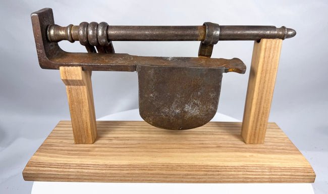 Detailed antique iron lock assembly with dark brown patina and hand-forged surfaces