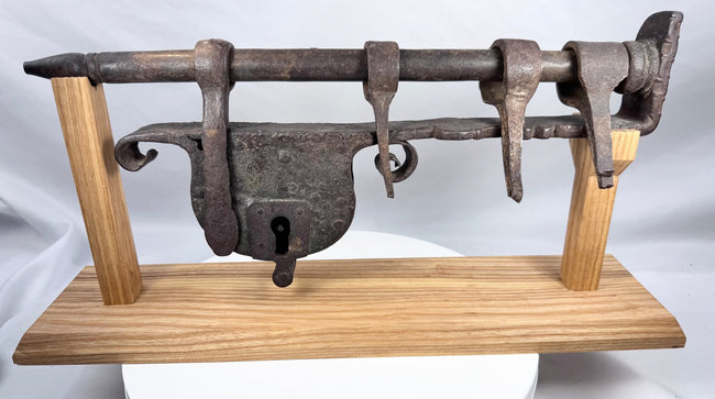 Historic 18th-century gate lock showing its riveted iron body and traditional keyhole