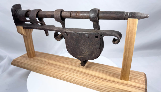 Hand-forged European door lock displaying extensive hammer marks and aged oxidation
