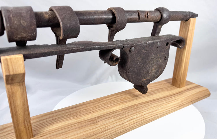 Historic European sliding hasp lock featuring decorative scrolling iron terminals