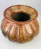 Ancient Peruvian ceramic vessel with flared rim and painted drip-pattern decoration.