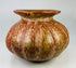 Globular Andean ceramic jar with flared lip and vertical painted motifs.