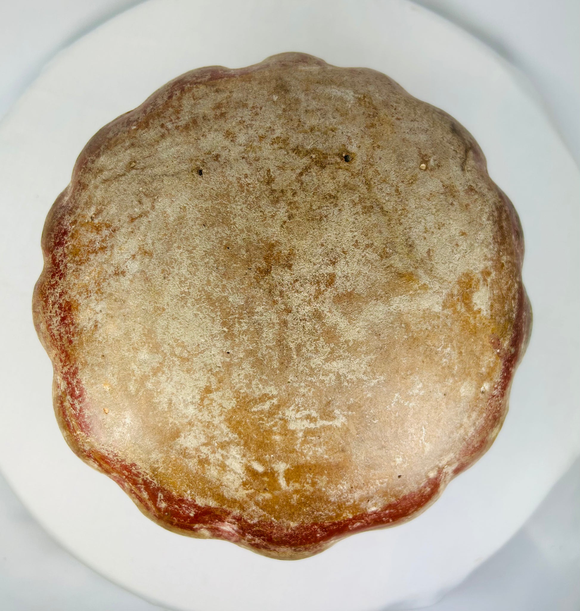 Bottom view of Pre-Columbian ceramic vessel showing textured base and natural wear.