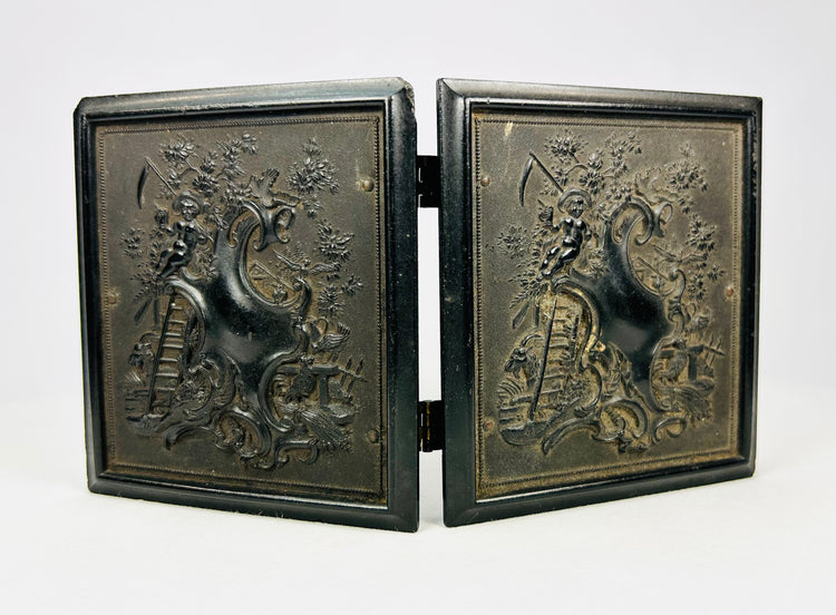 Antique 19th-century photograph case showing ornate raised exterior artwork