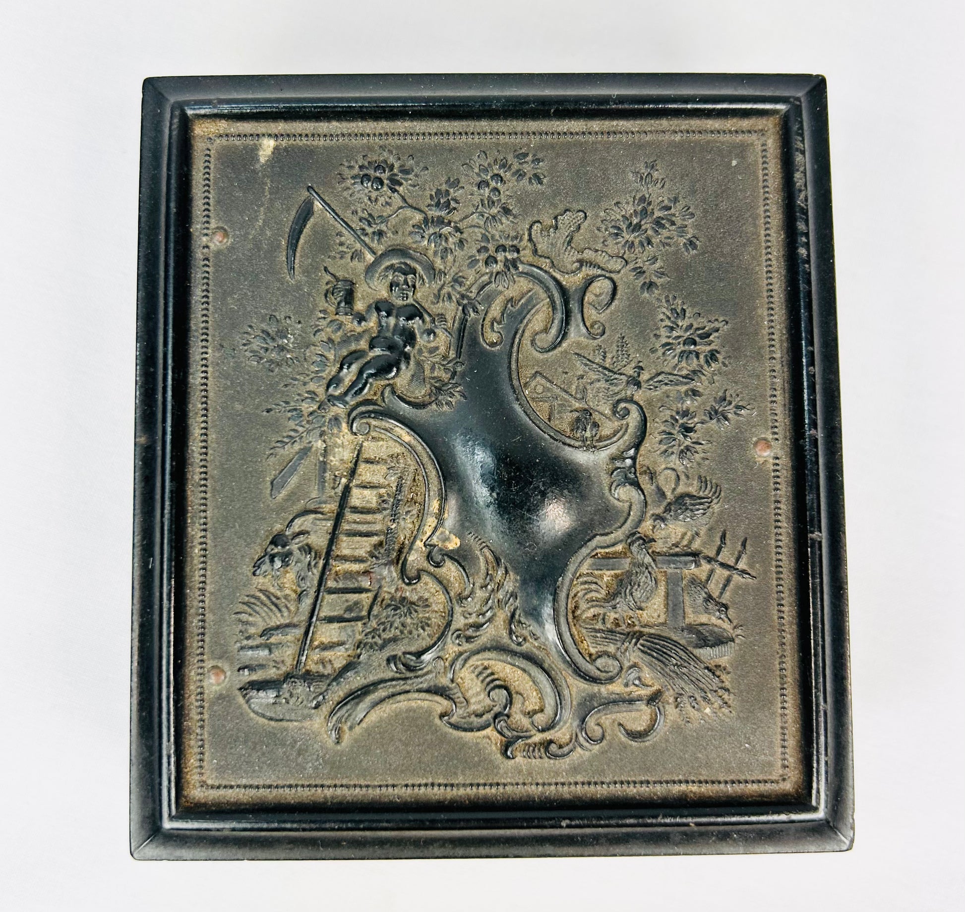 Embossed black Victorian photo case with intricate period design