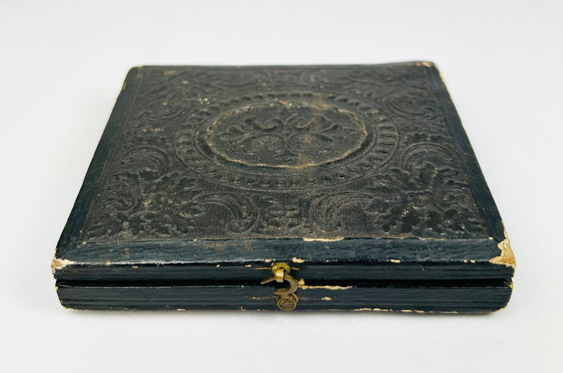 Civil War–era black leather photographic case with gold clasp, closed view