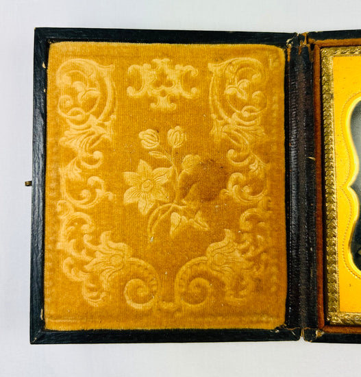 Victorian yellow velvet case lining with embossed floral scrollwork, ambrotype interior