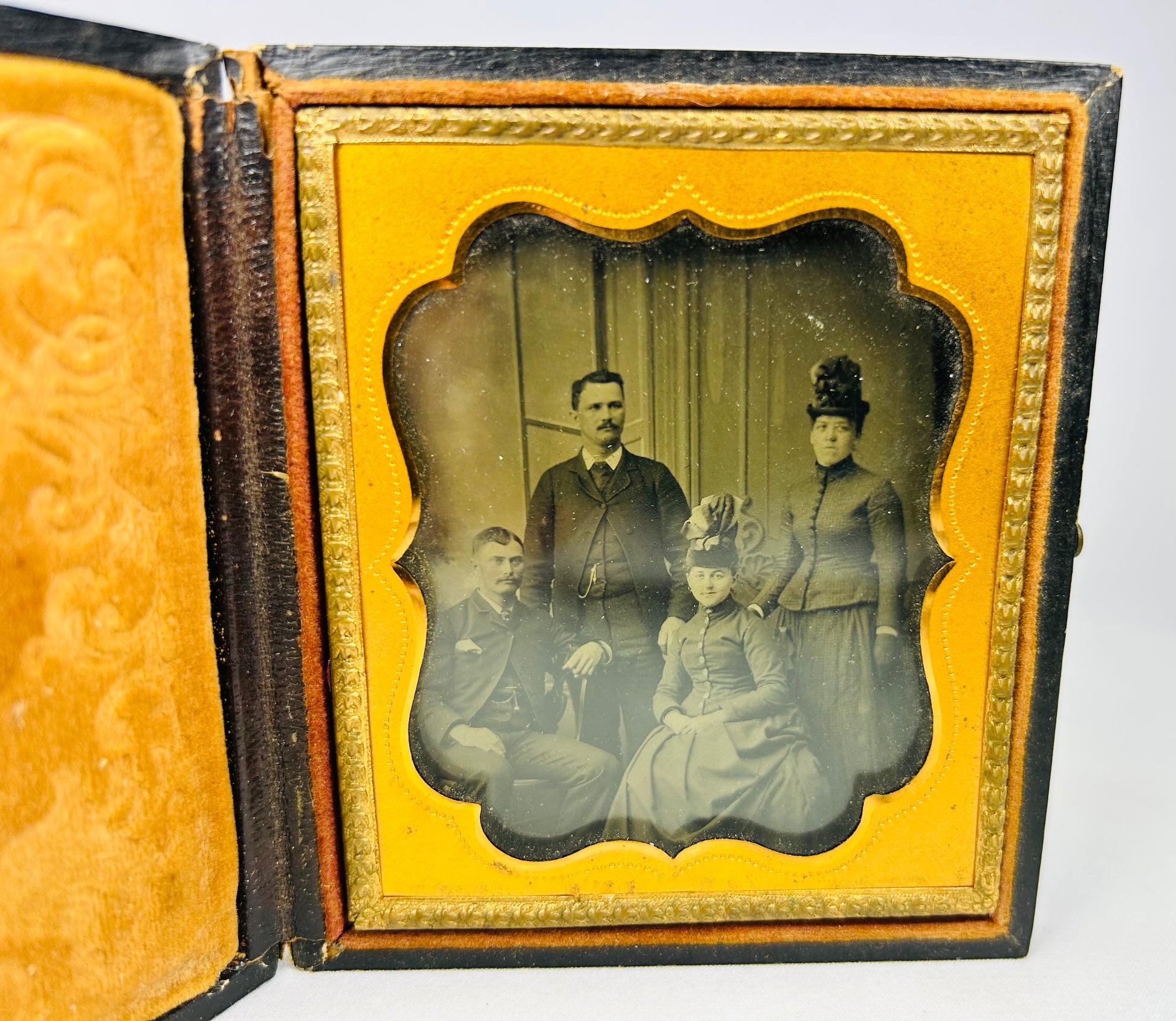 Ambrotype portrait of a Boston family from the 1860s in a yellow velvet-lined case