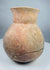 Side angle of an ancient globular pottery vessel with a constricted shoulder and tall neck