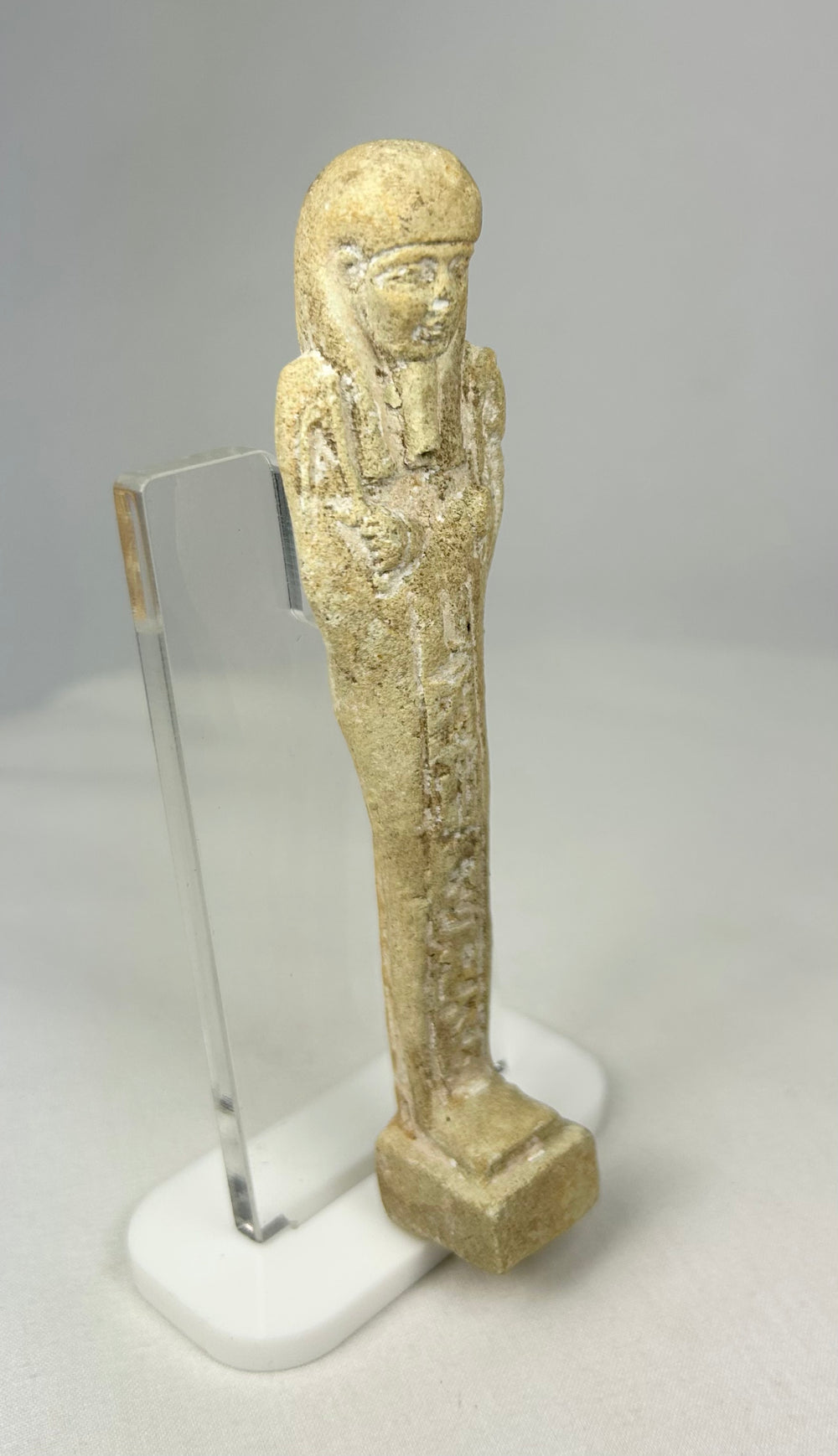 Angled side view of an Egyptian ushabti showing faint traces of pigment
