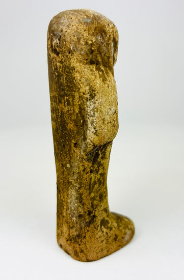 Ancient funerary ushabti figure photographed on a clean studio background.