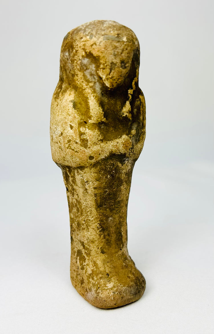 Late Period Egyptian ushabti carved in sandstone photographed upright.