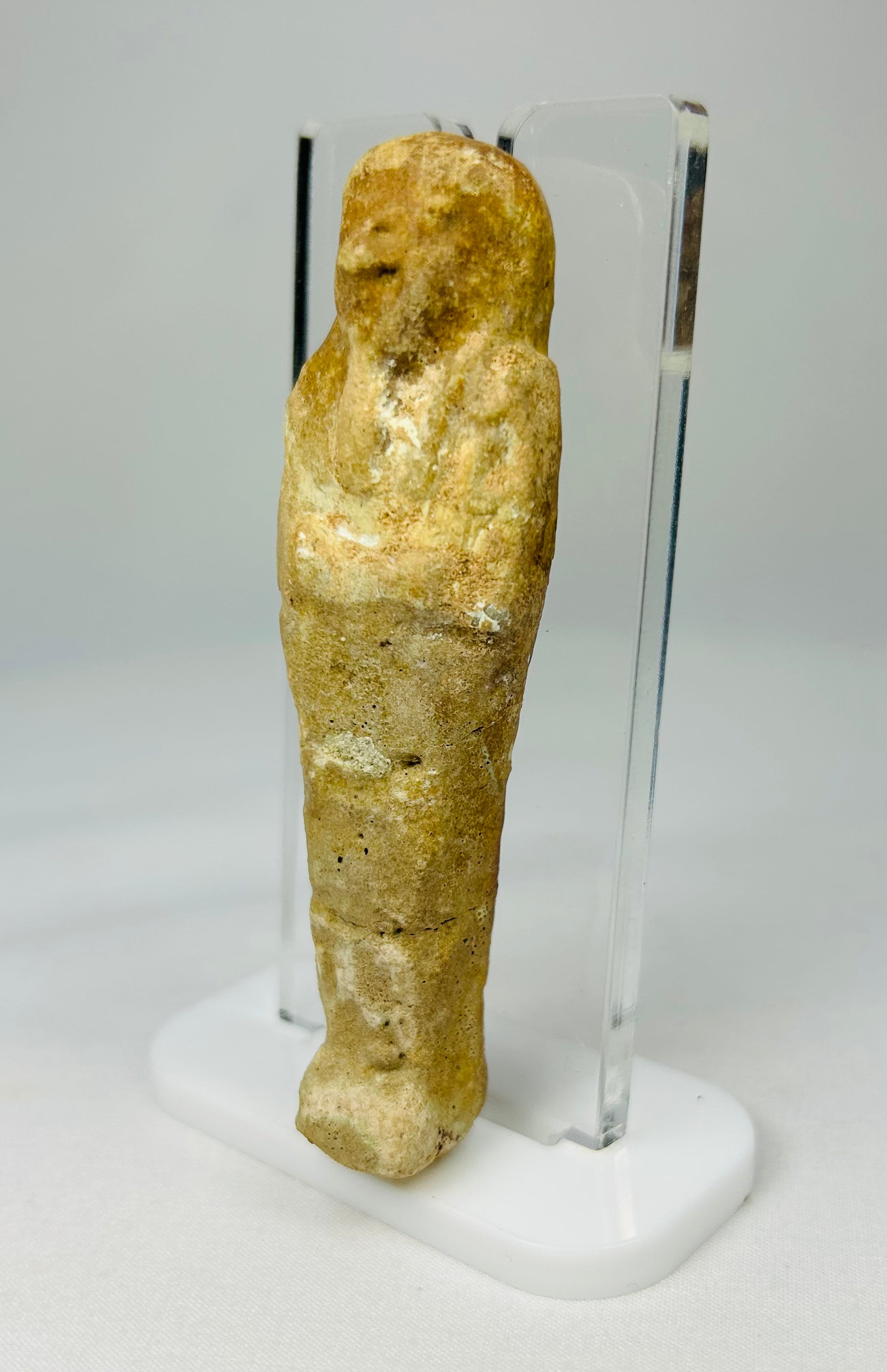 Historic Egyptian burial figurine with faint facial features and aged patina