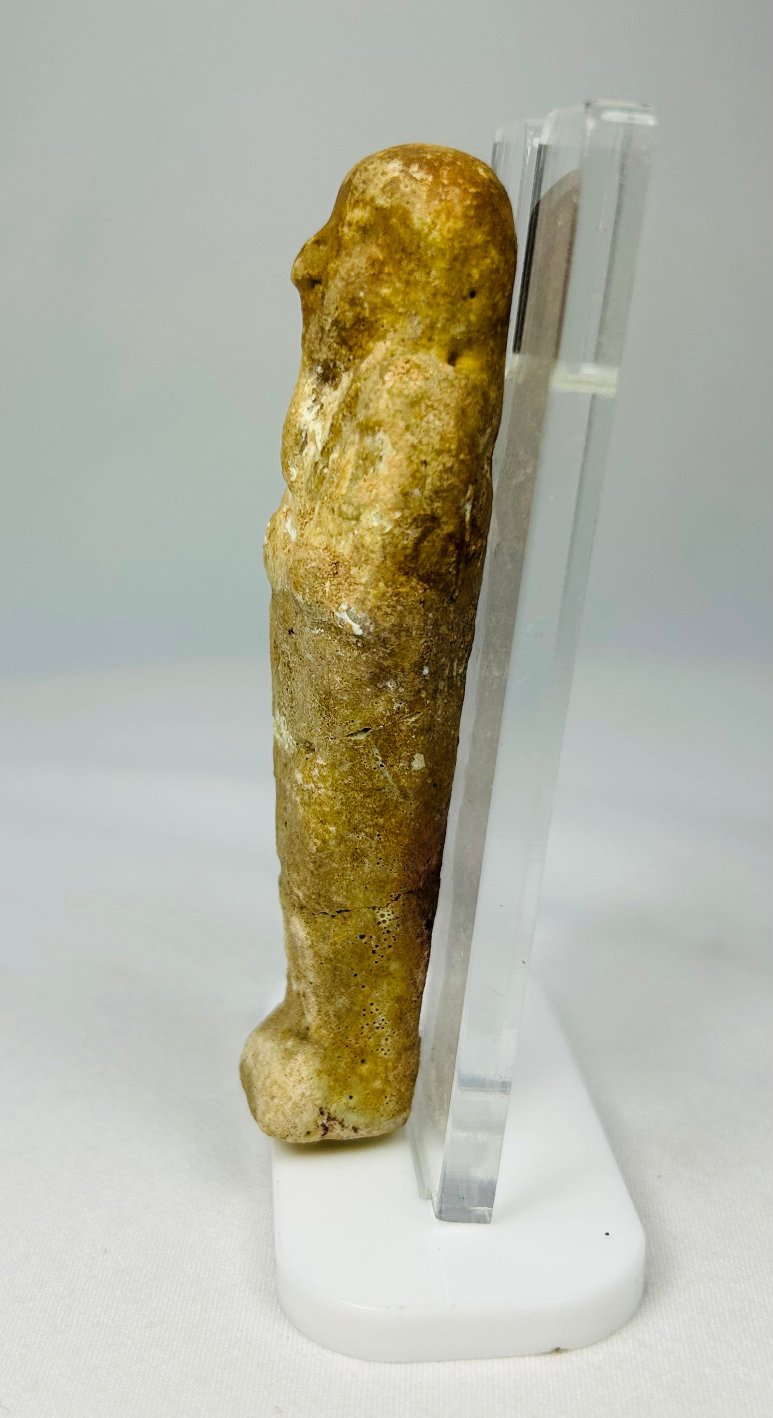 Ancient funerary ushabti figurine photographed on a clean white backdrop