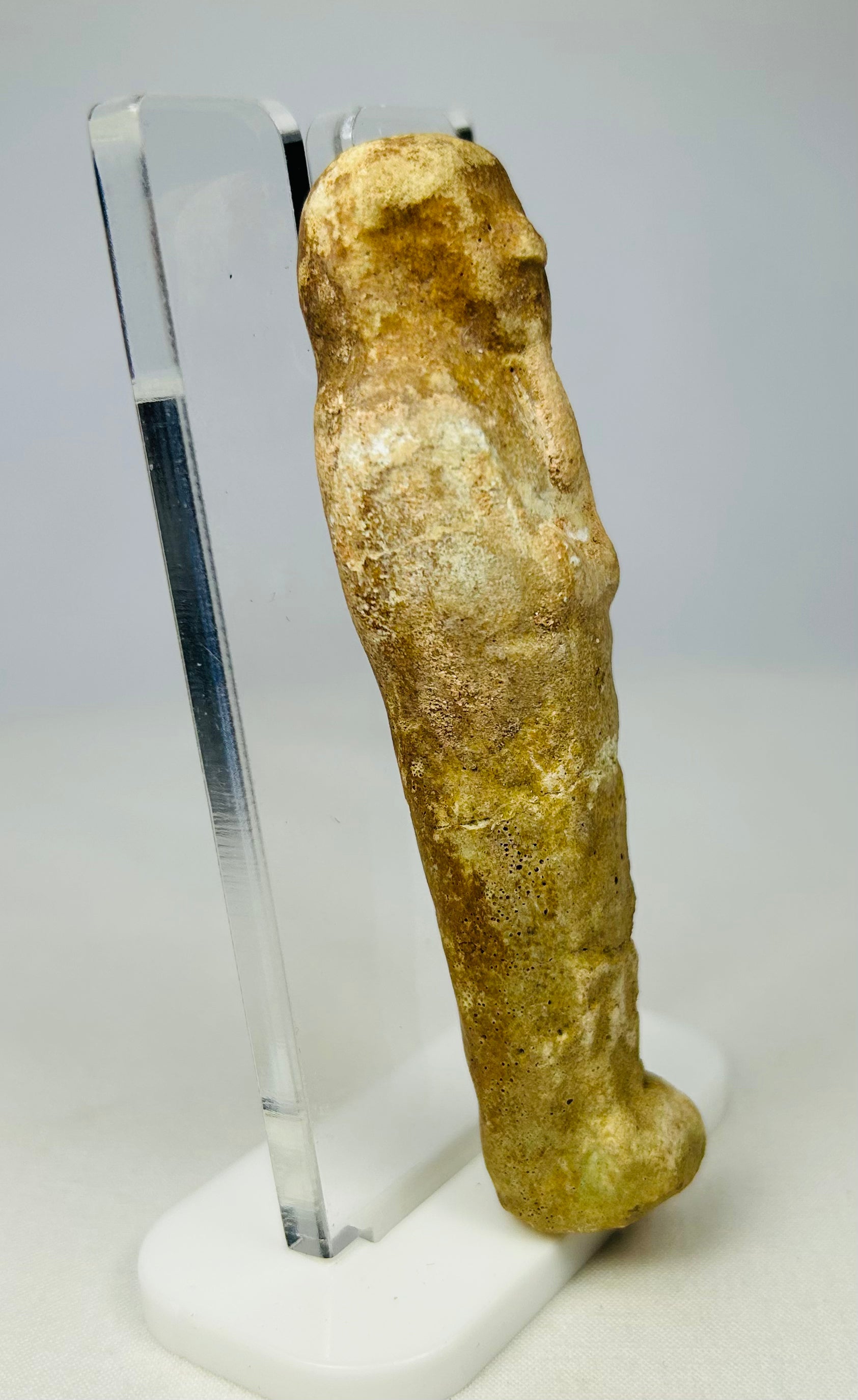 Ancient Egyptian worker-figurine ushabti displayed on a pedestal base