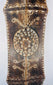 Lower section of a carved ceremonial shield with geometric borders and rounded point