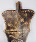Side profile of the large African ceremonial shield showing its carved form and rear handgrip