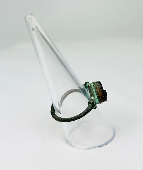 Historic bronze ring with natural patina photographed for cataloging