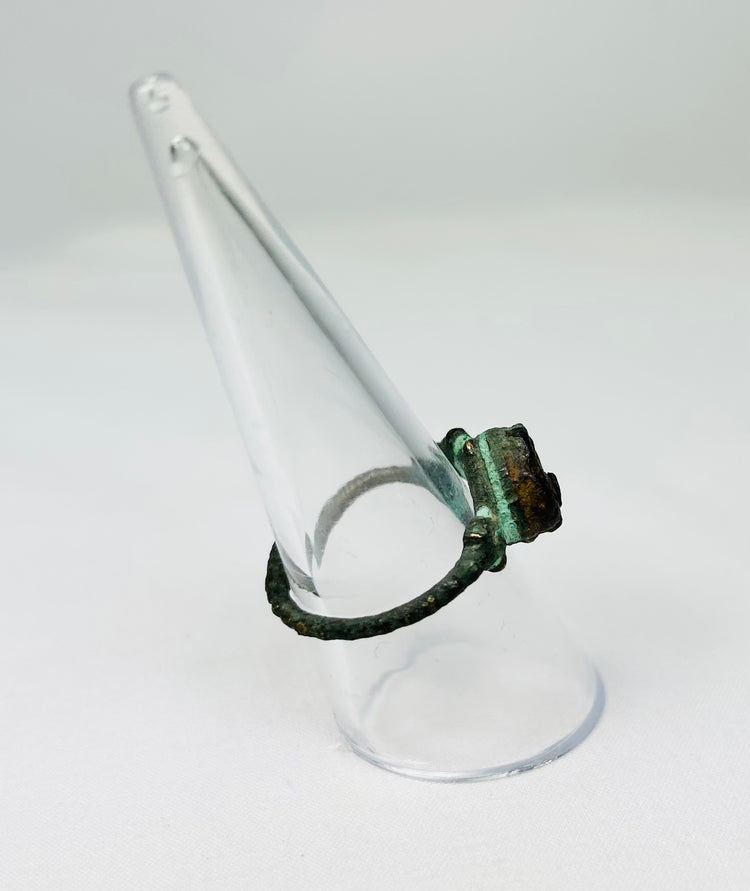 Historic bronze ring with natural patina photographed for cataloging