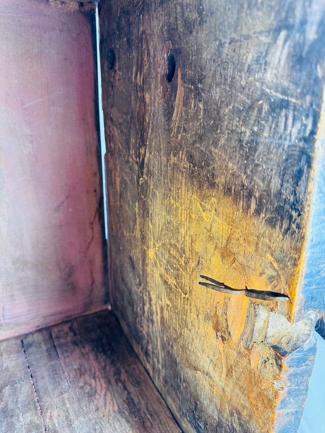 Carved Indian storage cabinet with warm exposed wood and dark recessed details