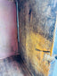 Carved Indian storage cabinet with warm exposed wood and dark recessed details