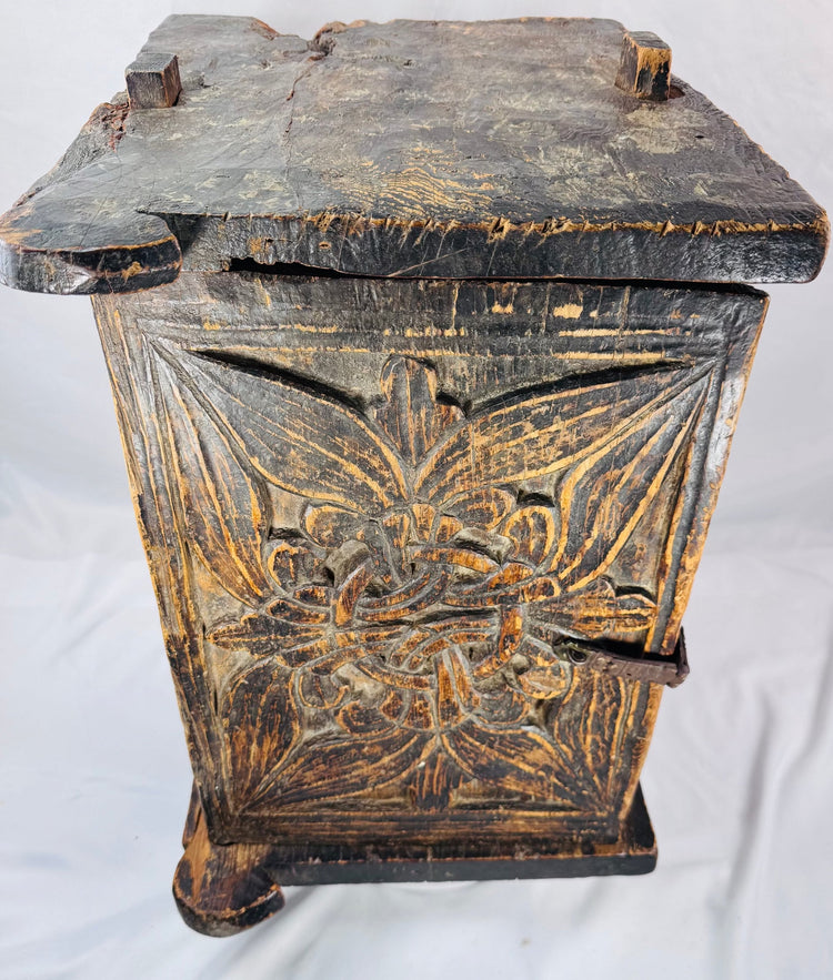 Indian carved wood cabinet decorated with scrolling vines, leaves, and blossoms