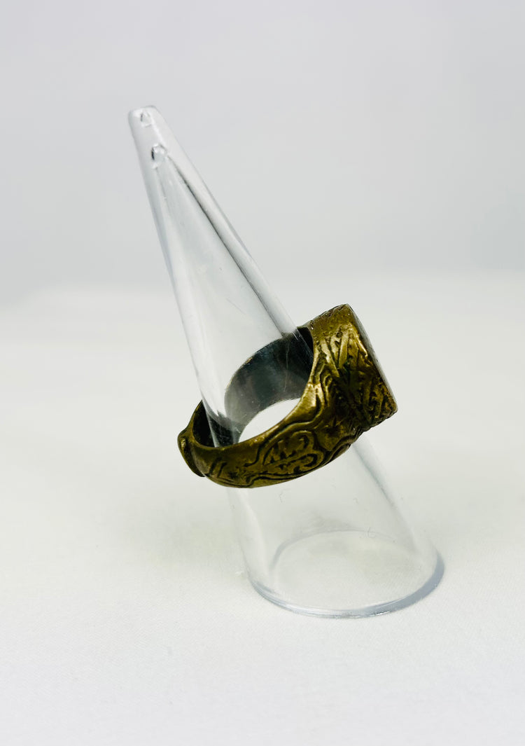 Historic bronze ring showcasing geometric band engravings and wear
