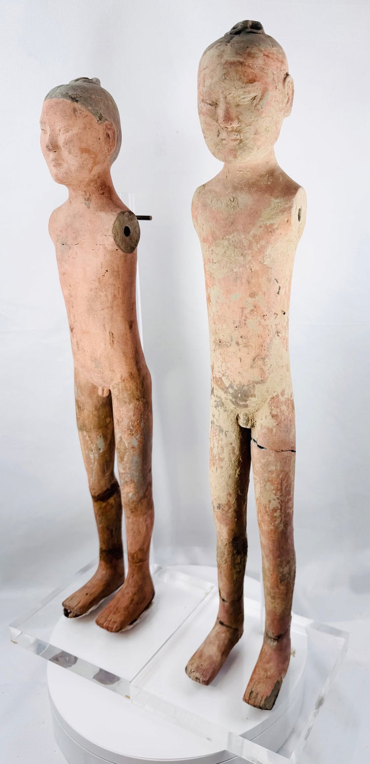 Western Han male tomb figure with modeled face, topknot, and shoulder apertures
