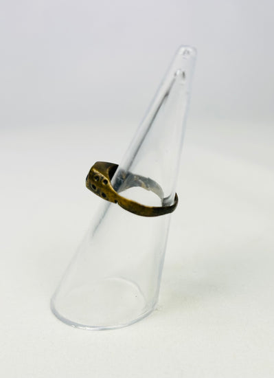 Aged copper-alloy ring showing engraved oval bezel