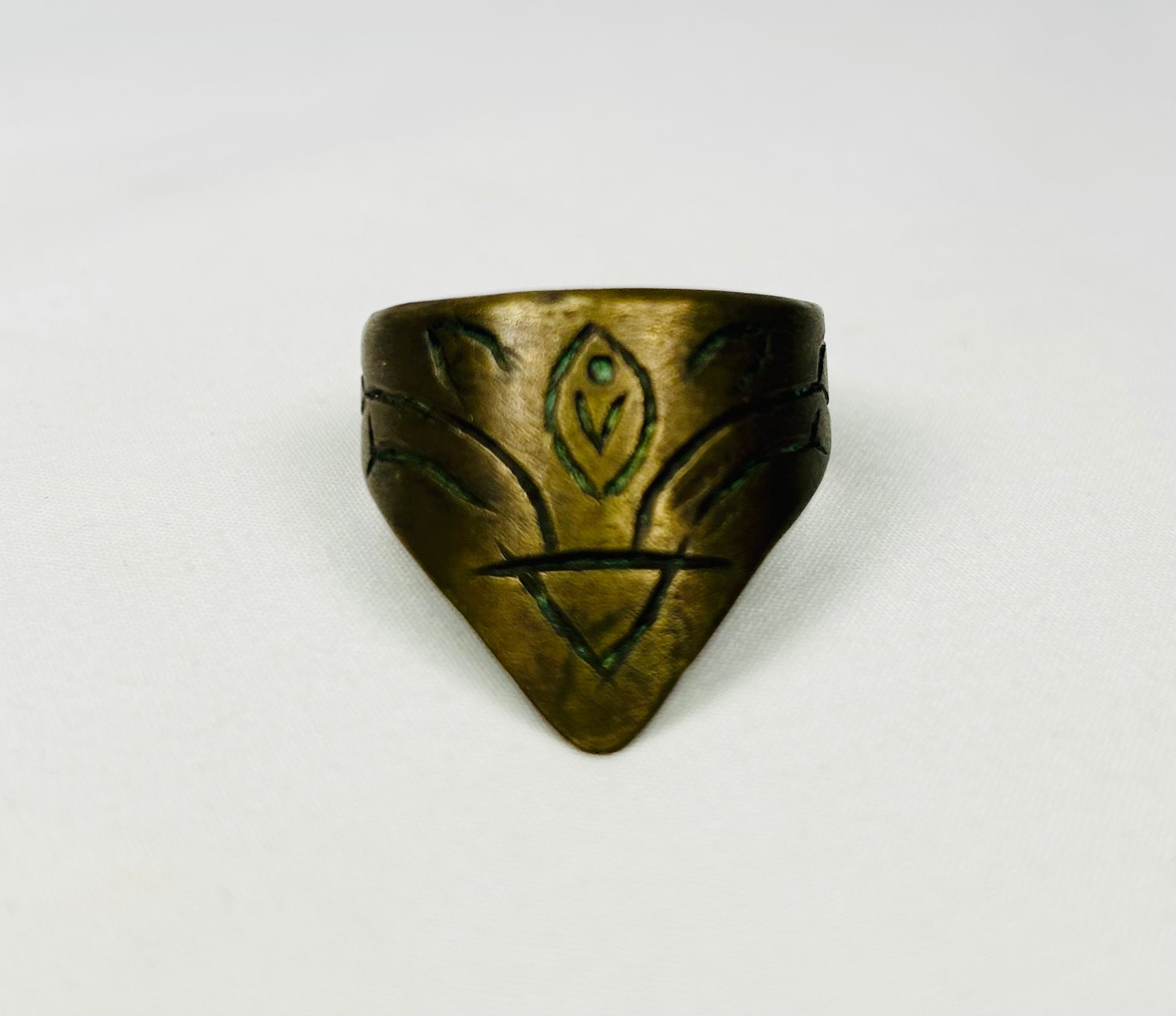 Ancient brass thumb guard with engraved motifs