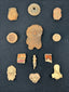 Pre-Columbian terracotta faces, idols, and pottery pieces arranged in a display frame