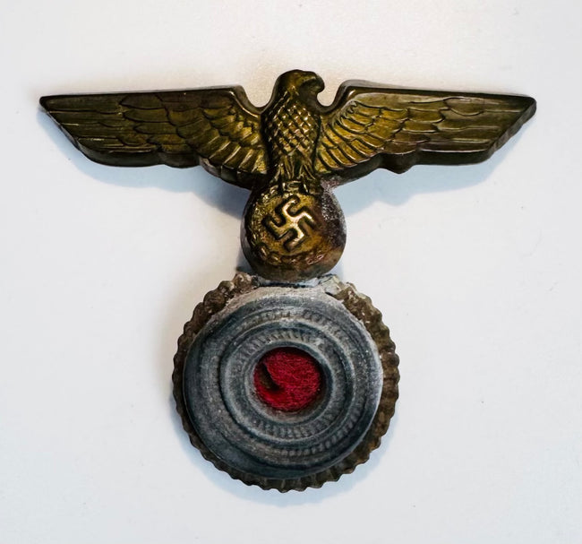Kriegsmarine junior NCO cap insignia with aged gilt patina and red felt center